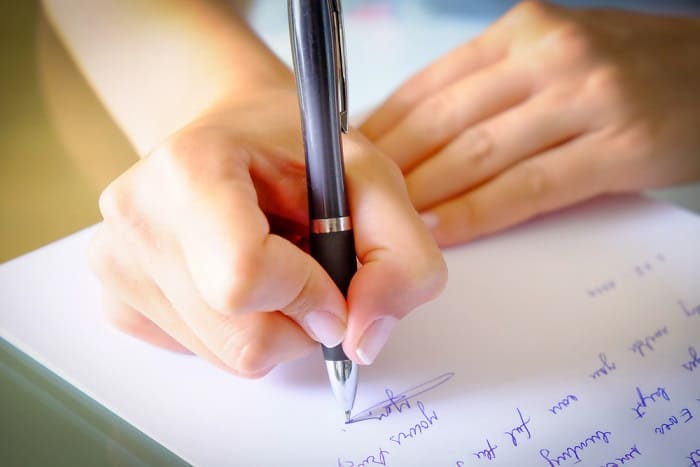 Parent writing a letter of intent to homeschool