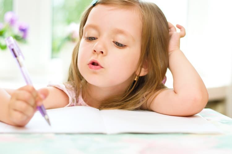 Small girl writing