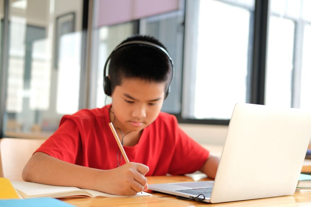 Boy wearing headphones at computer